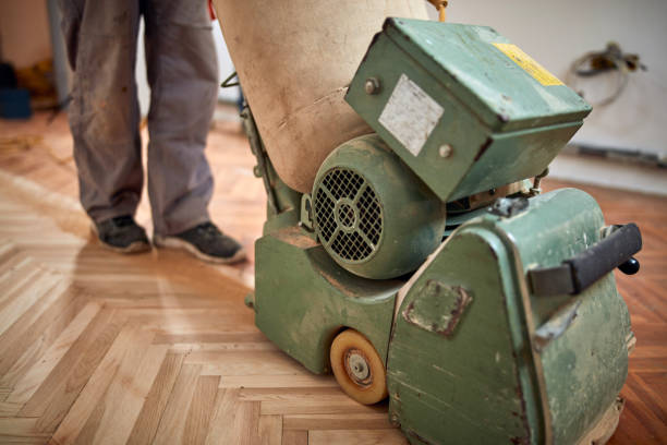 istock Repairman restoring parquet with a sanding machine. 1341683760