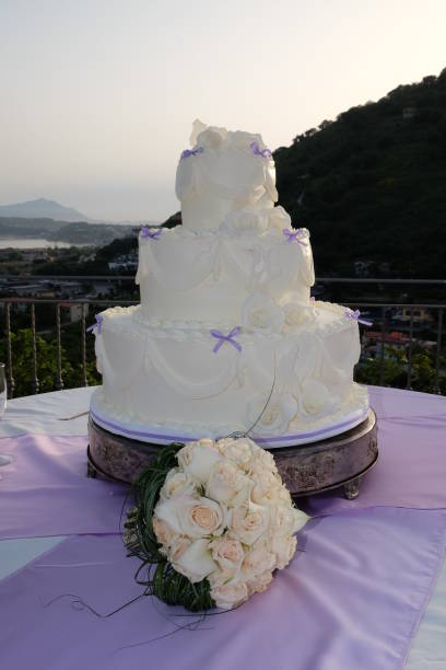 istock Wedding cake on the table ready for cutting by the newlyweds. 1341686364