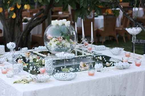 Wedding table with favors and confetti.