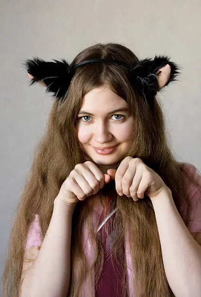 Girl in black fur ears play cat