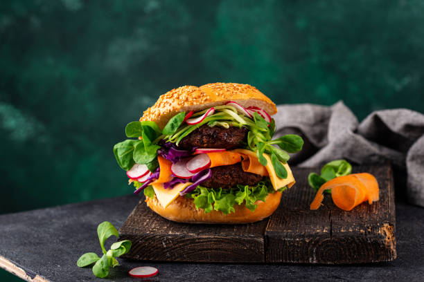Burger with vegetables and plant-based cutlet Vegetarian cheeseburger with vegetables and plant-based cutlet from lentils. meat substitute stock pictures, royalty-free photos & images