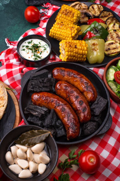 istock Grilled sausages, meat, and vegetables. 1341690176