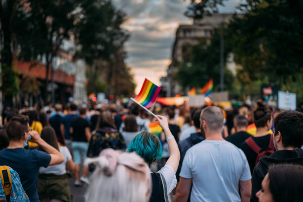 LGBTQIA Pride March In Belgrade Rear view of people marching down the street at a pride parade in Belgrade, Serbia, on September 18th, 2021 gay pride symbol stock pictures, royalty-free photos & images