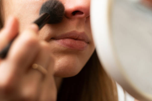 istock Girl makes herself makeup. close-up. makeup mirror. 1341691944