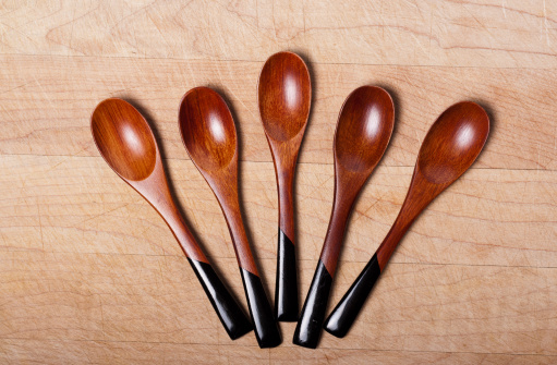 Beautiful Japanese handcrafted wooden spoons arranged on a wooden board
