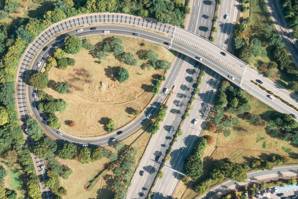 istock Cars drive along loop shaped road junction aerial view. 1341693617