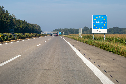 large road sign with the French locations to reach the city of Paris or Amiens and other places