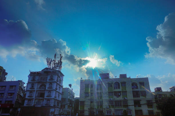 Kolkata, West Bengal, India - 20th July 2019 : Kolkata cityscape , modern architecture of buildings, Sun rays bursting through clouds, blue sky in background.