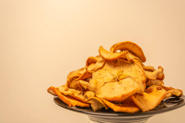 istock Dried apples cut into slices on a warm background. 1341695615