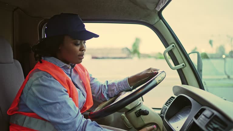 Young Female Truck Driver Checking Smart Phone