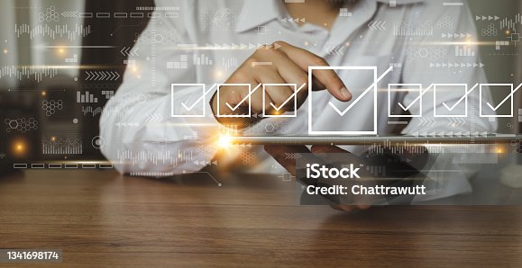 istock Businessman working with tablet. Checking mark up on the check boxes. Successful completion of business tasks. Digital marketing of statistics level up of graph. Business management goal strategy. 1341698174