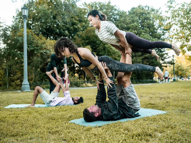 istock People practising Acro Yoga in the park 1341698230