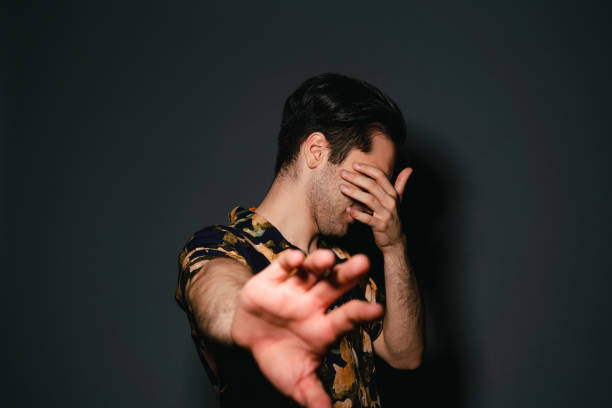 istock Vip person is protecting himself from the paparazzi 1341698575