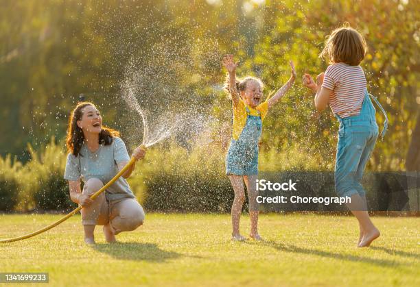 Happy Family Playing In Backyard Stock Photo - Download Image Now - Family, Summer, Child