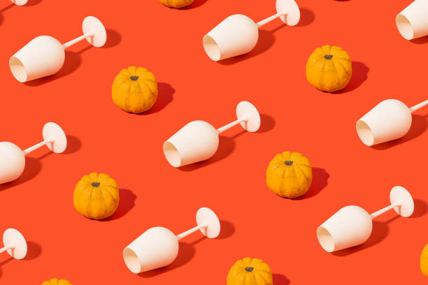 Trendy composition pattern with pumpkin and white broken wine glass on orange red background. Trendy composition pattern with pumpkin and white broken wine glass on orange red background.  Halloween or thanksgiving party wallpaper. thanksgiving live wallpaper stock illustrations