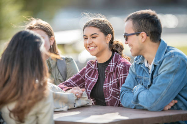 istock University Students Sitting at a Table Outside 1341700797