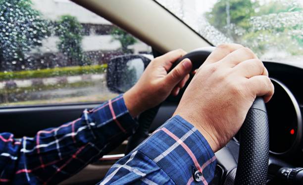istock Businessman driving with both hands on steering wheel selective focus. safety driving concept. 1341701196