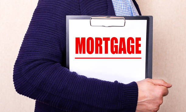 istock A man holds in his hands a tablet on which is written in red MORTGAGE 1341702116