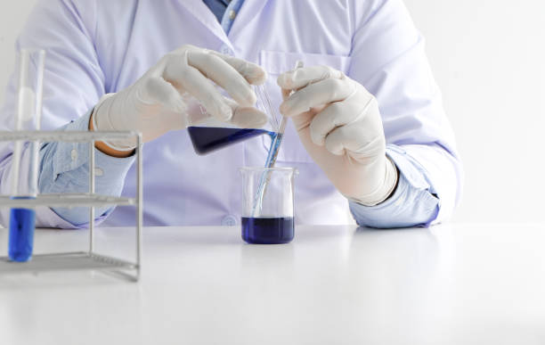 istock Science innovative Male medical or scientific laboratory researcher performs tests with blue liquid in laboratory. equipment science experiments technology Coronavirus Covid-19 vaccine research 1341703263