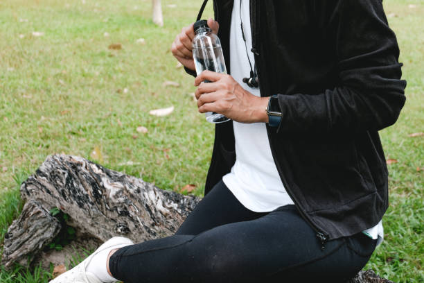 istock Sportswoman drinking some water from a bottle after training. 1341703292