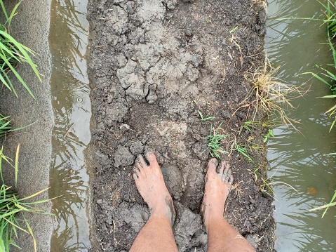 man's feet are full of mud