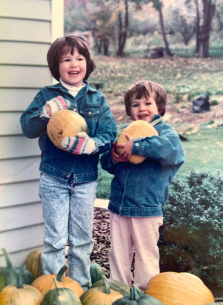 istock Two Sisters holding Pumpkins they Grew 1990 1341705999