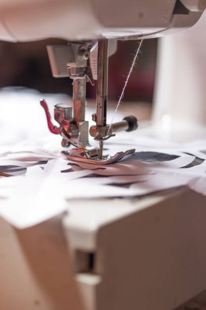 istock Sewing machine with a needle. Macro photo of a sewing needle. White sewing machine. 1341709288