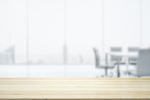 Empty office wooden table with empty space on modern conference room with large window background, closeup, mock up