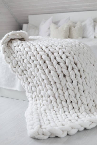 istock White nordic bedroom interior with knit plaid 1341711083