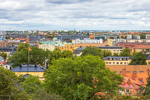 Beautiful panoramic view over city landscape under blue sky with puffy white clouds. Europe. Sweden. Uppsala.