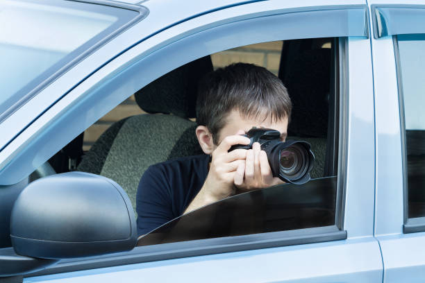 istock A man is taking photo someone or something from an open car window 1341712314