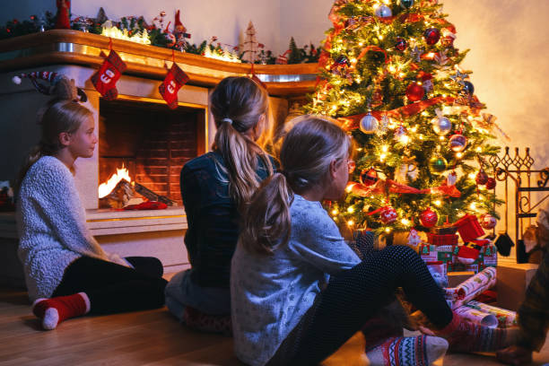 istock Little Kids Sitting in Front of Christmas Tree 1341713997