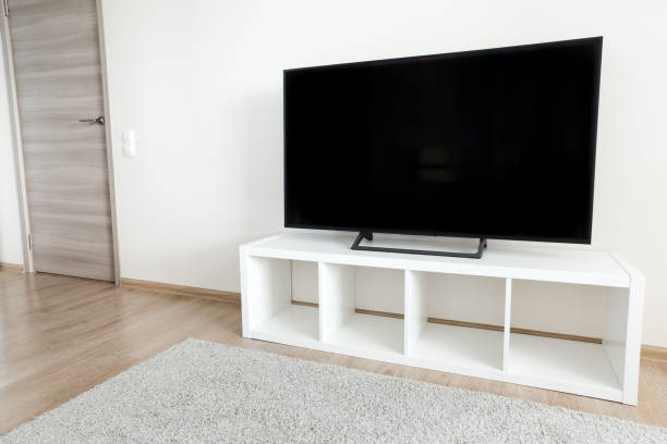 istock Lcd tv on white shef at modern room interior 1341714612