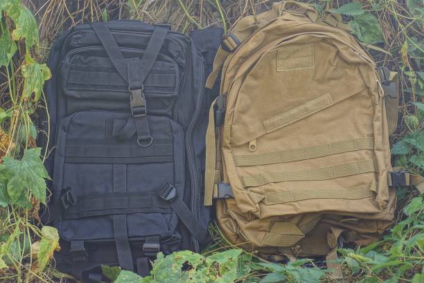 istock two tactical military backpacks in green and black 1341715758