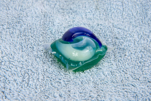 istock Colorful gel capsule for washing on blue material soft background 1341718518