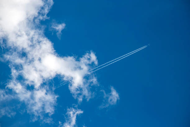 istock Airplane flying in the blue sky among clouds. 1341718652