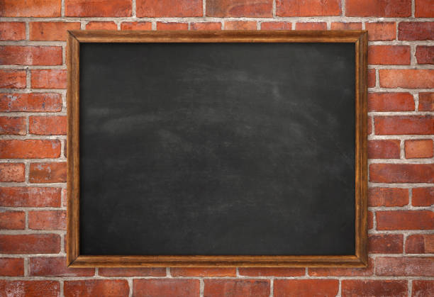 Wood framed chalkboard on old red brick wall