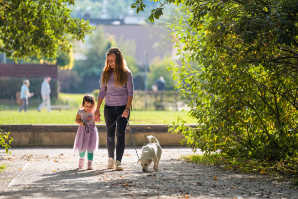 istock Daughter and Mother Walking in a Public Park 1341723320