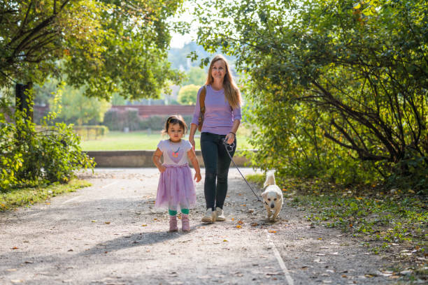 istock Daughter and Mother Walking in a Public Park 1341723327