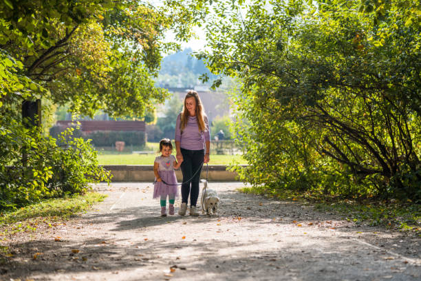 istock Daughter and Mother Walking in a Public Park 1341723331