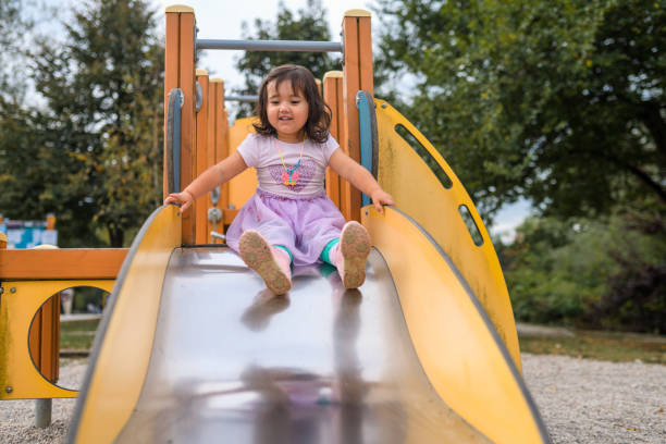 istock Young Girl About To Go Down the Slide 1341723366