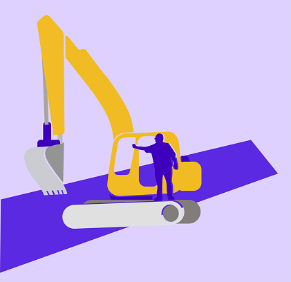 A man standing on a backhoe