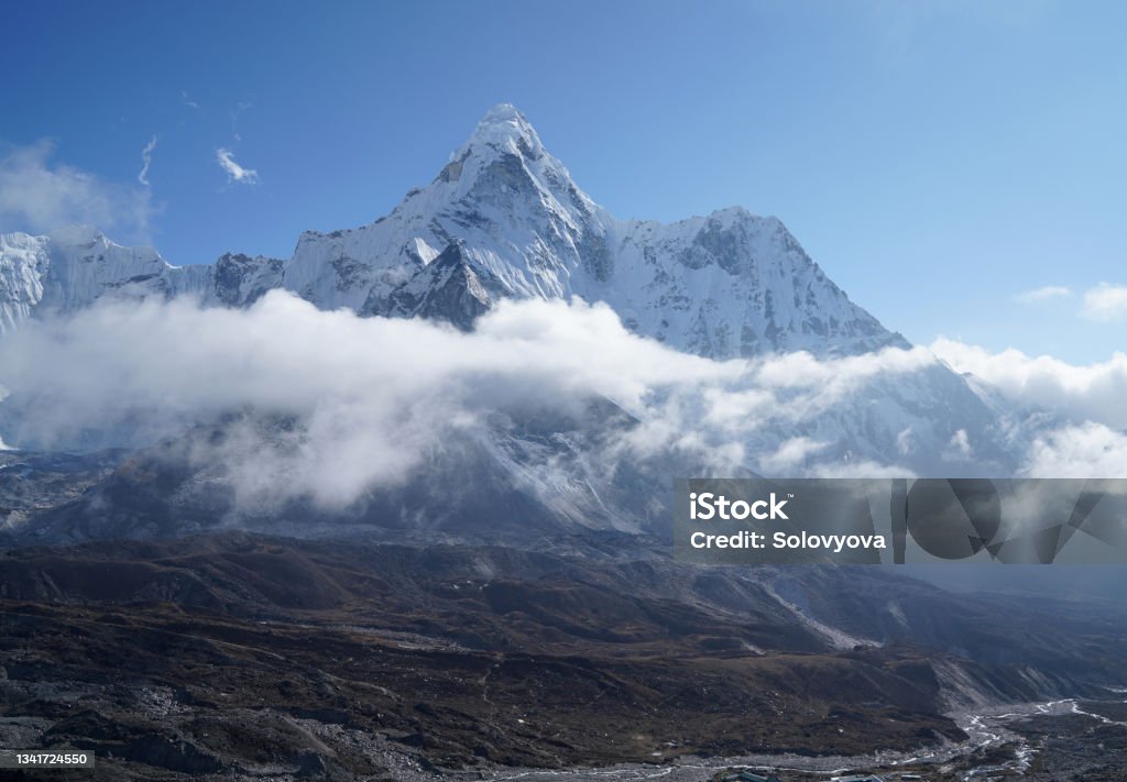 Ama Dablam 6814m clouds covered peak View near Dingboche settlement in Sagarmatha National Park, Nepal. Everest Base Camp (EBC) trekking route. Himalayas Stock Photo