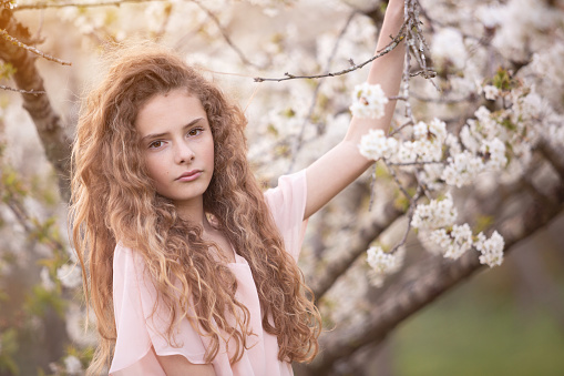 17 years-old beautiful girl surrounded by cherry trees flowered - Sunset time - Spring -Argentina