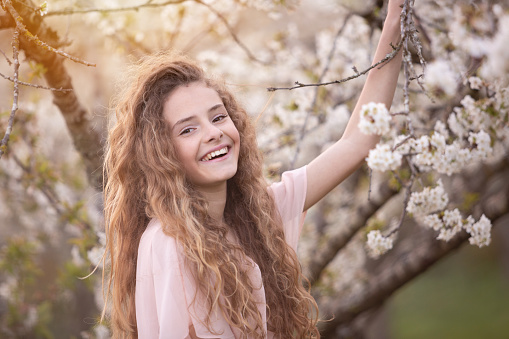 17 years-old beautiful girl surrounded by cherry trees flowered - Sunset time - Spring -Argentina