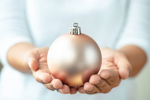 Hand Holding Christmas Bulb