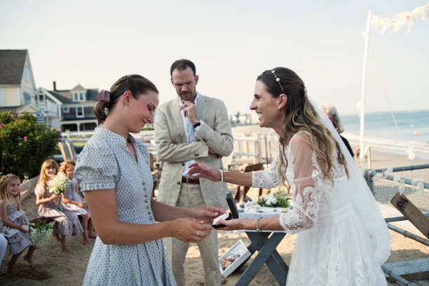 istock Bride giving gift to her daughters during small wedding. 1341738866