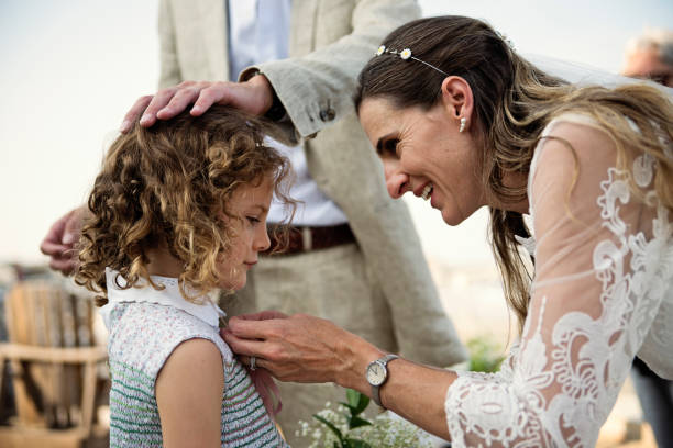 istock Bride giving gift to her daughters during small wedding. 1341739568