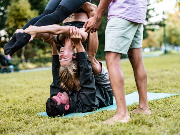 istock People practising Acro Yoga in the park 1341739624