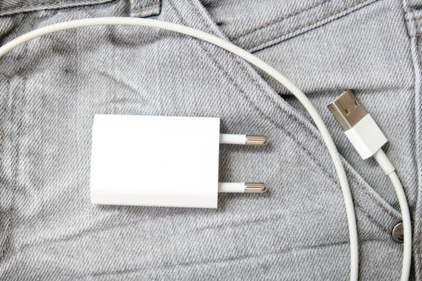 ładowarka usb, przewód i wtyczka adaptera w szarej kieszeni dżinsów, nie zapomnij o ładowarce w domu - plug adapter charging mobile phone battery charger zdjęcia i obrazy z banku zdjęć